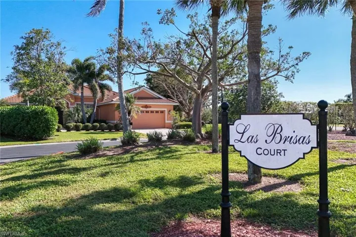 Community / neighborhood sign with a yard