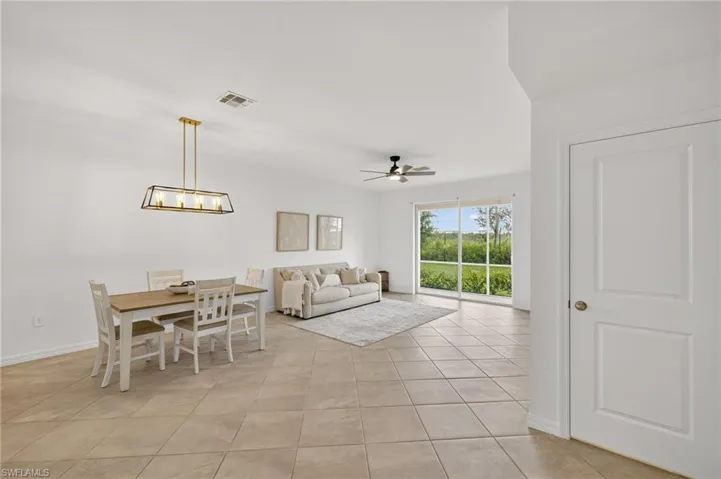 Dining room with ceiling fan and light tile patterned flooring
