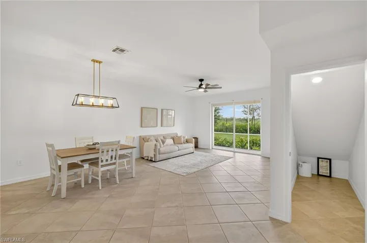 Dining room featuring ceiling fan and light tile patterned flooring