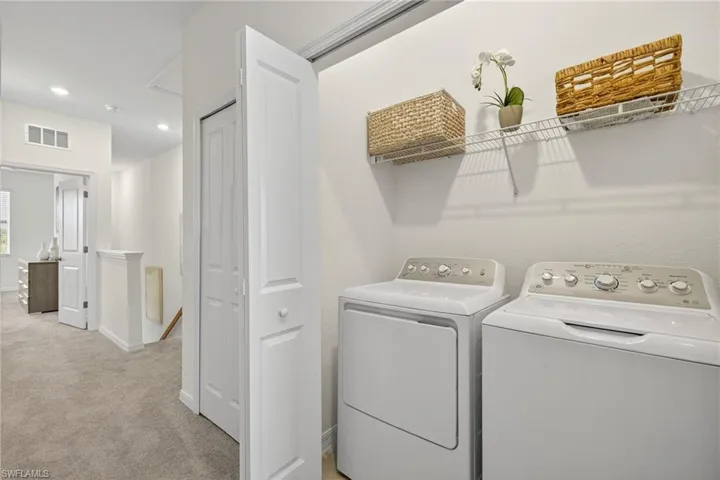 Laundry area featuring washer and clothes dryer, light carpet, and recessed lighting