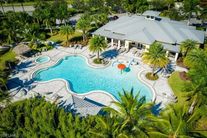 Community pool featuring a hot tub and a patio area