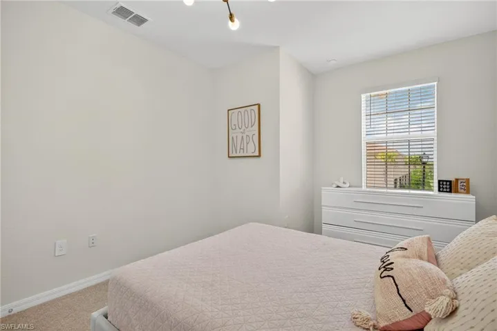 Bedroom featuring carpet and baseboards