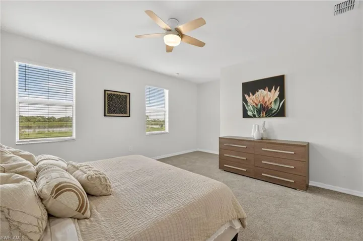 Bedroom featuring light colored carpet and ceiling fan