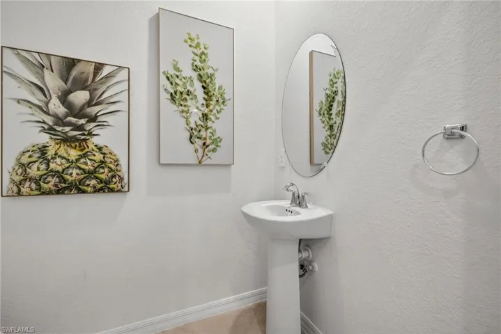 Bathroom featuring baseboards and a sink