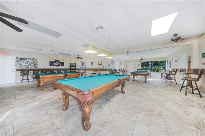 Recreation room featuring billiards table, ceiling fan, and a drop ceiling
