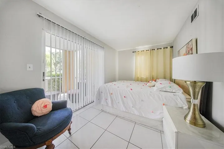 Bedroom featuring access to exterior and tile patterned flooring