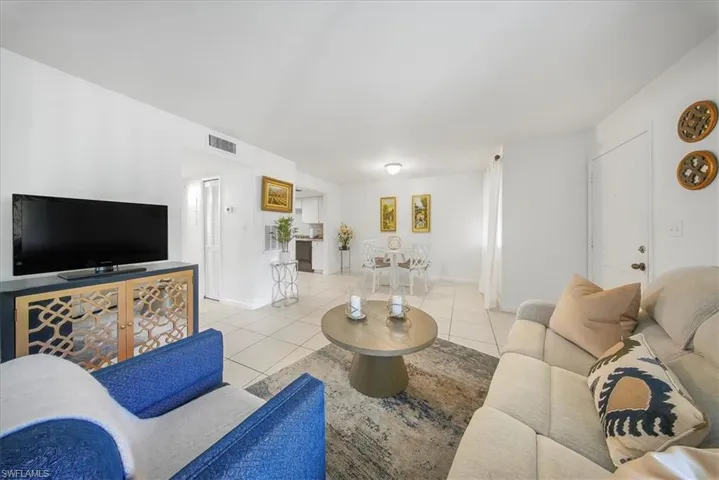 Living room with light tile patterned floors