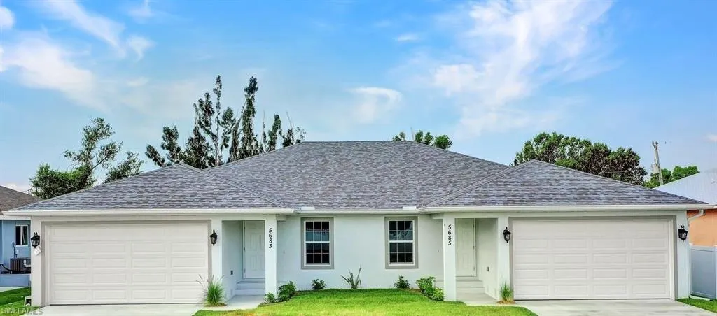 Ranch-style home with a garage, concrete driveway, and stucco siding
