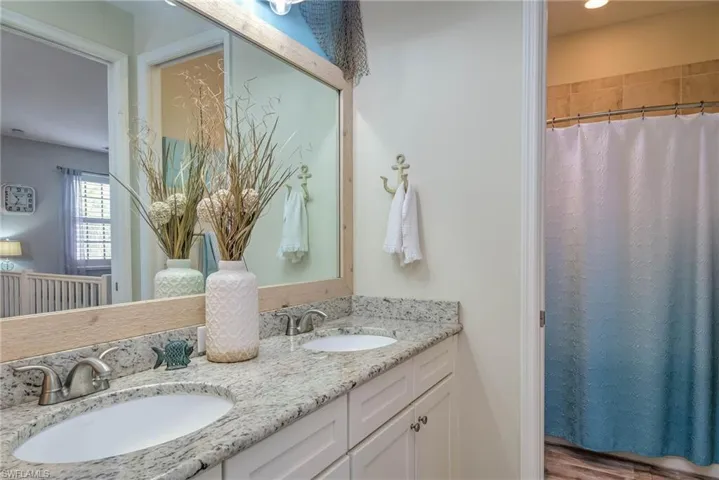 Guest Bathroom featuring double vanity