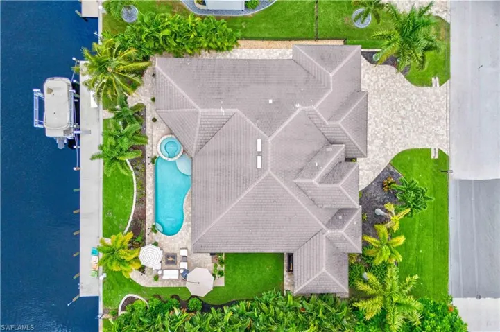 Birds eye view of property with a water view