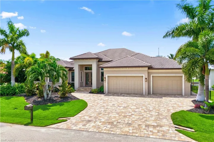 Prairie-style house featuring a garage and a front lawn