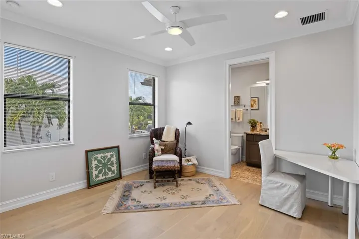Sitting room featuring ceiling fan, light wood-type flooring, and a wealth of natural light