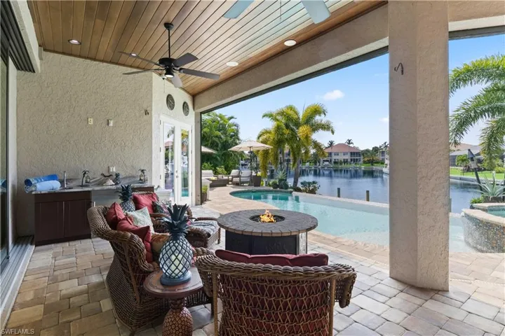 View of patio / terrace with a water view and ceiling fan