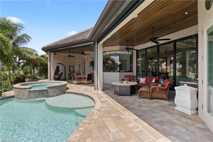 View of pool featuring ceiling fan, an outdoor hangout area, an in ground hot tub, and a patio area