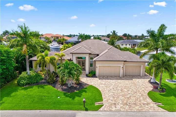 View of front facade with a garage and a front lawn