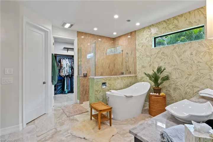 Bathroom featuring shower with separate bathtub