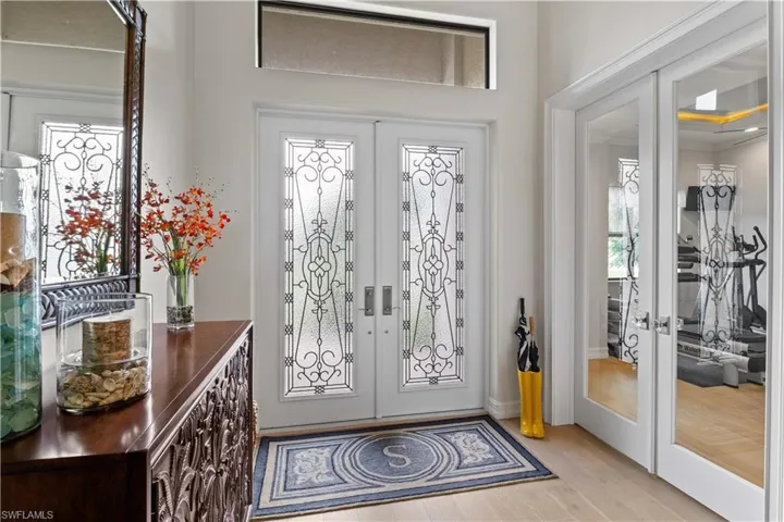 Foyer featuring light hardwood / wood-style flooring and french doors