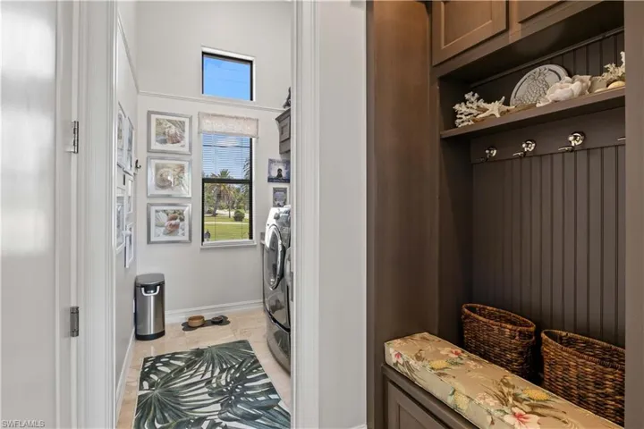 Mudroom featuring washer / clothes dryer and light tile patterned floors