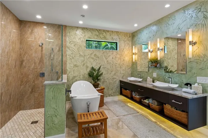 Bathroom featuring independent shower and bath and vanity