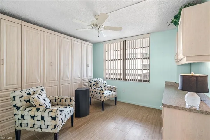 Sitting room featuring light hardwood / wood-style flooring, a textured ceiling, and ceiling fan