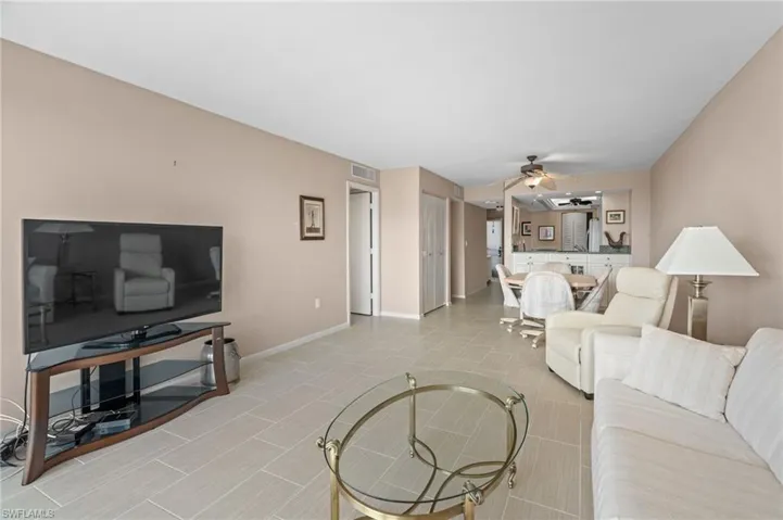 Living room featuring ceiling fan and light tile patterned floors