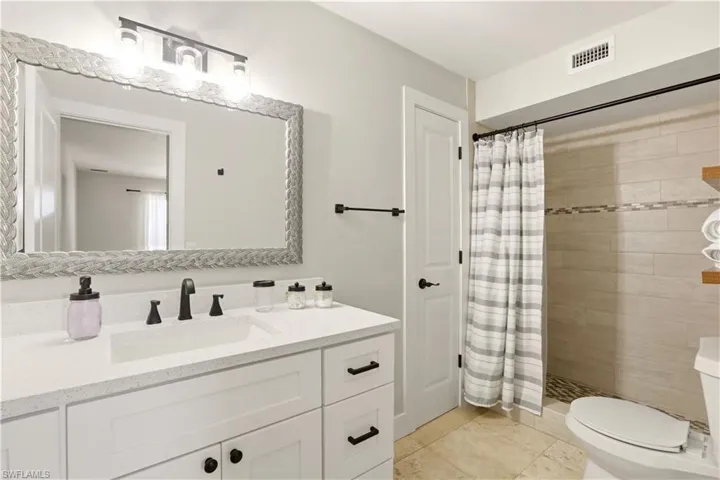 With walk in Shower and linen closet