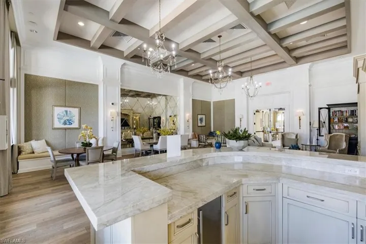 Kitchen with open floor plan, a high ceiling, and a chandelier