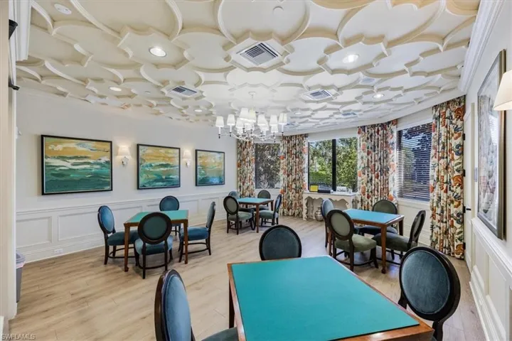 Dining space featuring visible vents, a decorative wall, and an inviting chandelier