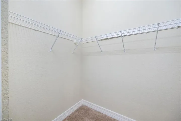 Walk in closet featuring carpet