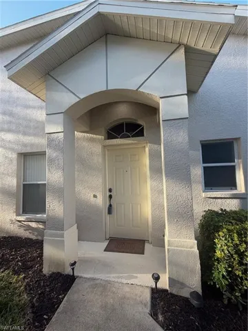 Entrance to property featuring stucco siding