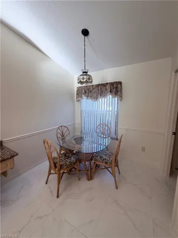 Dining room featuring light marble finish flooring