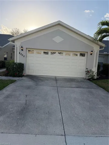 Ranch-style home featuring concrete driveway, stucco siding, and an attached garage