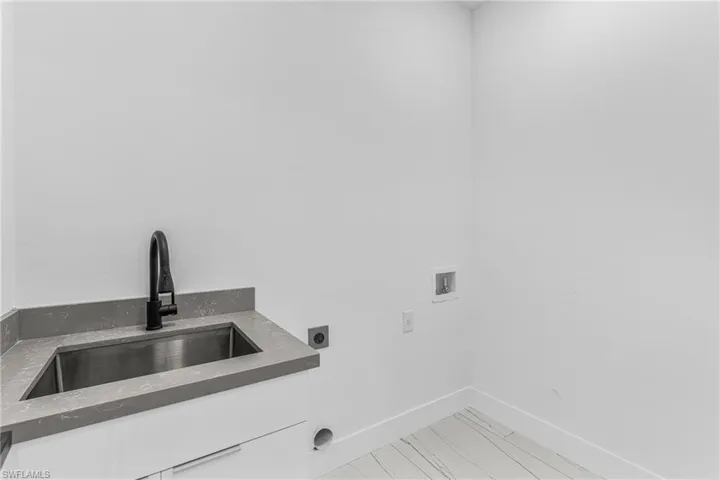 Laundry area with washer hookup, hookup for an electric dryer, and light wood finished floors