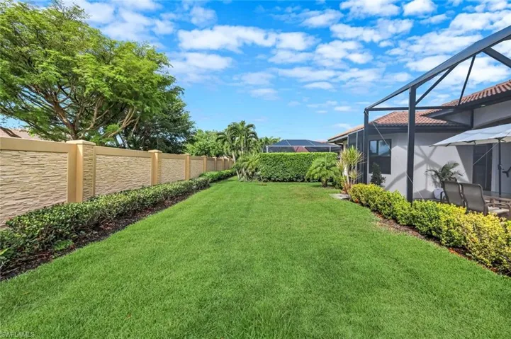 Fenced yard with a sunroom and a lanai