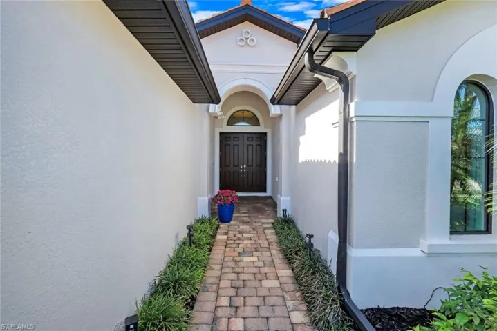 Entrance to property with stucco siding