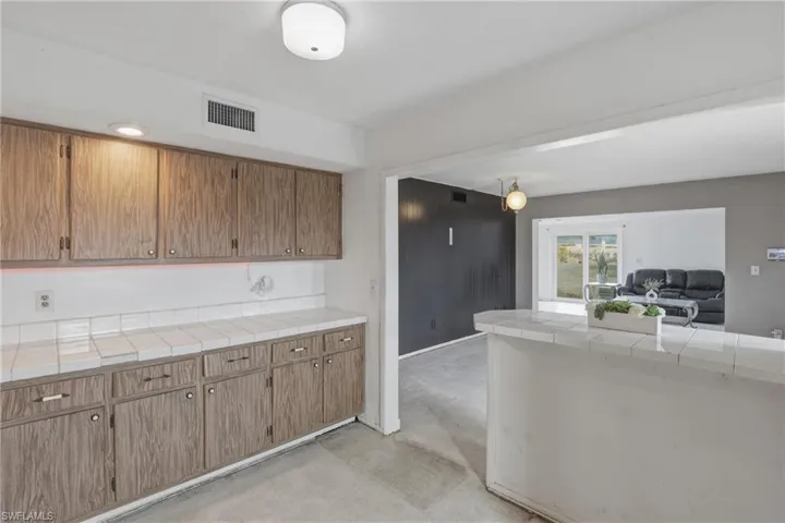 Kitchen featuring tile counters and open floor plan