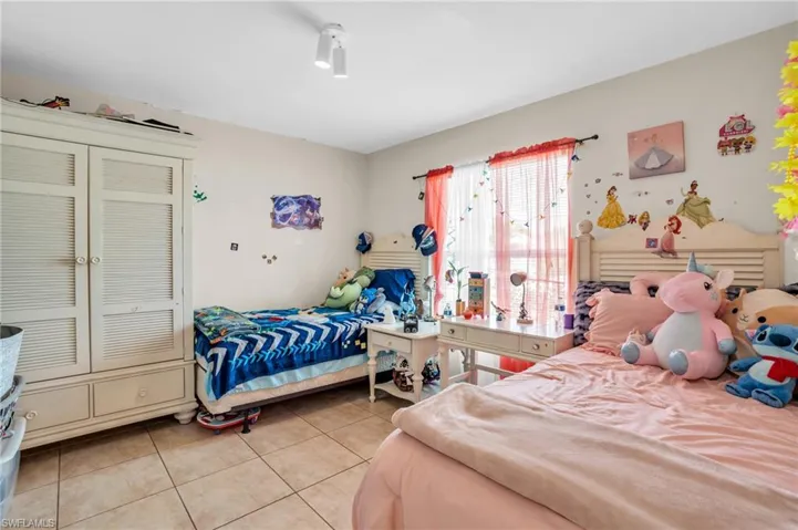 Tiled bedroom featuring a closet