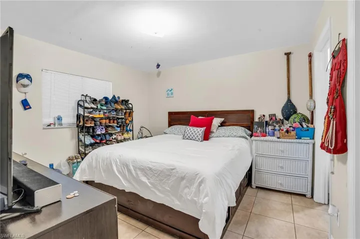 Bedroom with light tile floors
