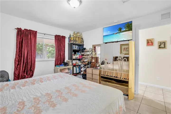 Bedroom featuring light tile floors