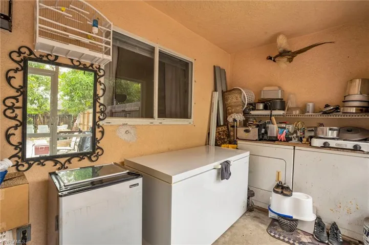Laundry room with a textured ceiling