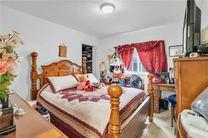 Bedroom featuring a closet and tile floors