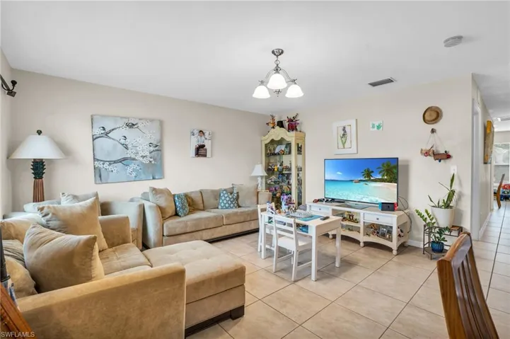 Tiled living room with a chandelier