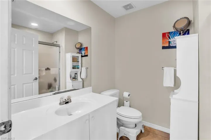 Bathroom with tile floors, vanity, and toilet