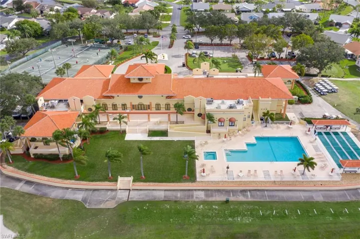 Aerial view of community center with pool, spa & bocce ball courts