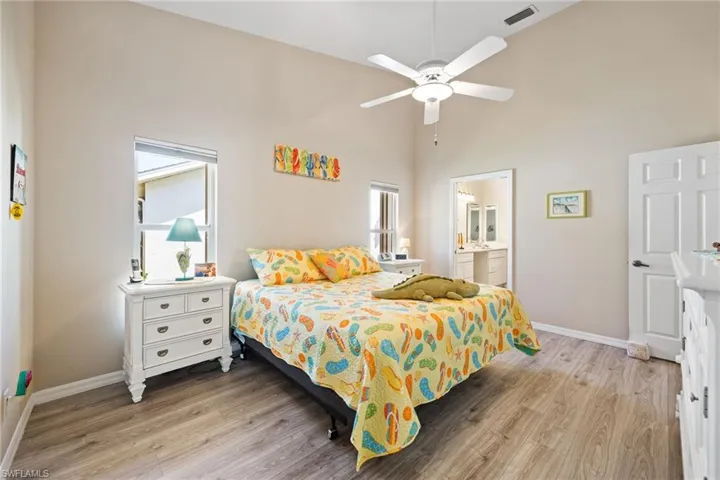 Spacious primary bedroom with laminate flooring & an en suite bathroom