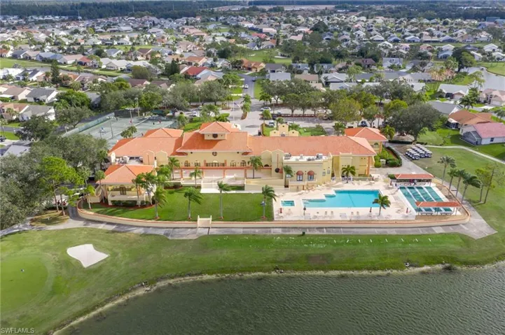 Rear view of community center, pool, spa & lake