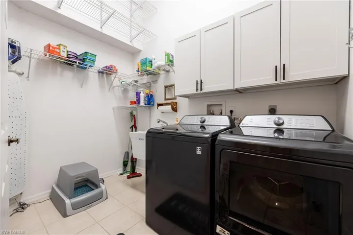 Laundry area with washer, dryer, laundry tub & storage