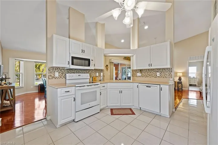 Kitchen with white cabinetry & quartz countertops