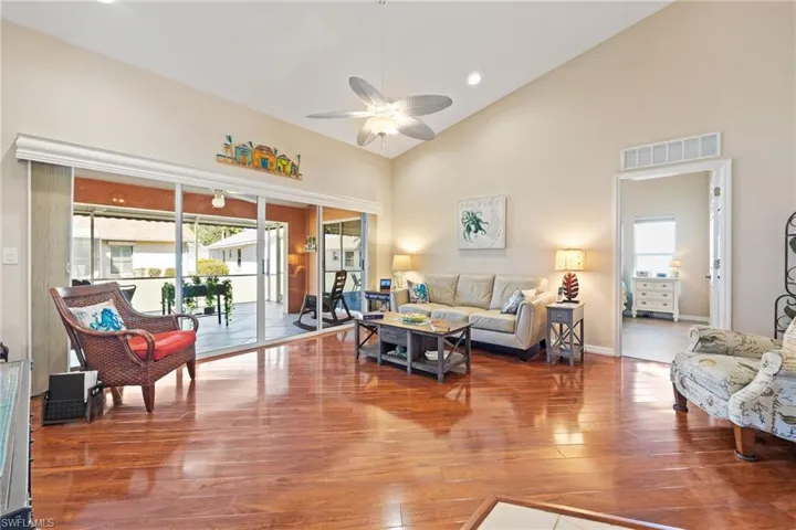 Living room with laminate flooring & cathedral ceiling
