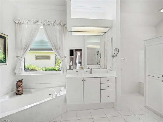 Primary bathroom with tub and separate shower.